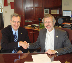 Handshake between Dr. Ralph Otto (NIFA) and Robert Pietrowsky (IWR) after signing of the Interagency Agreement