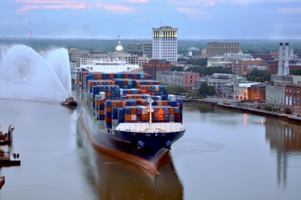 Waterborne Commerce - Picture of a tugboat assisting a container ship to port.